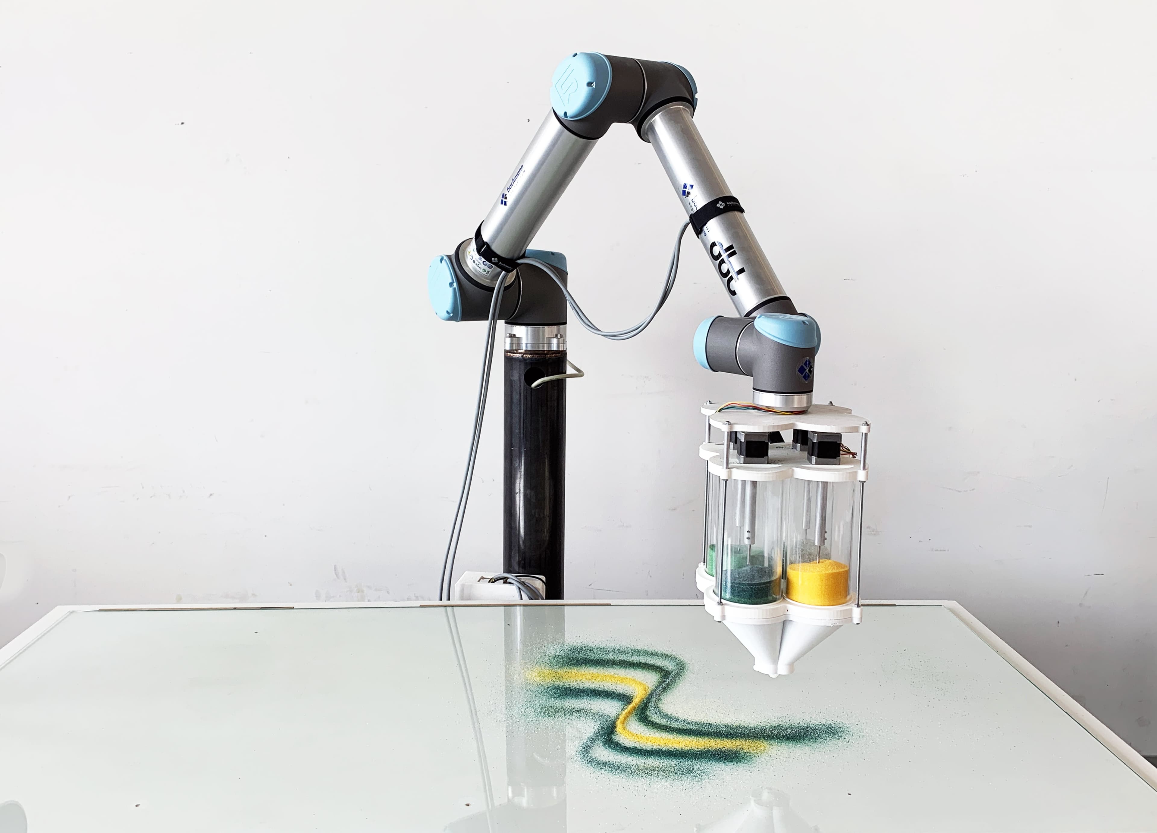Universal Robots UR10 arm depositing glass granules