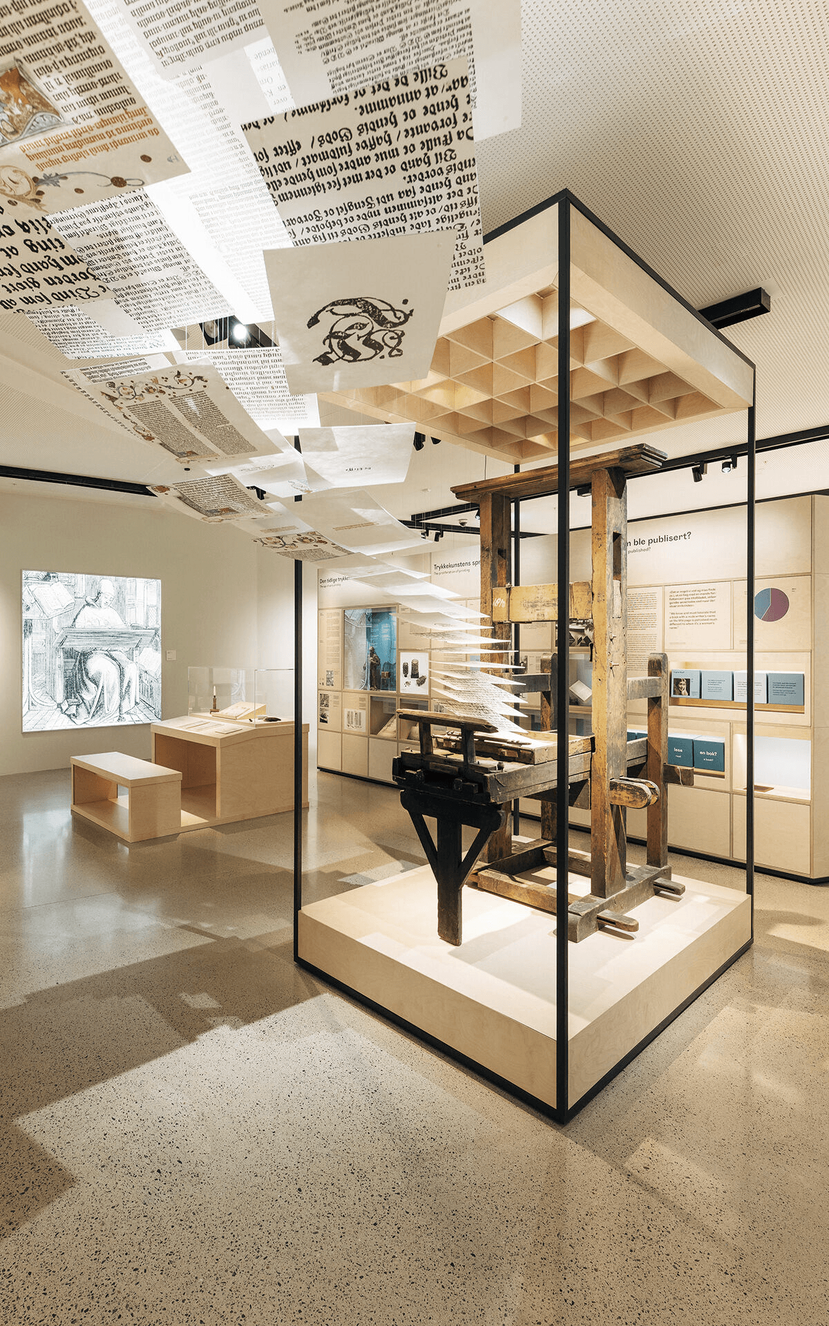 Cascading printed sheets over the wooden press exhibit