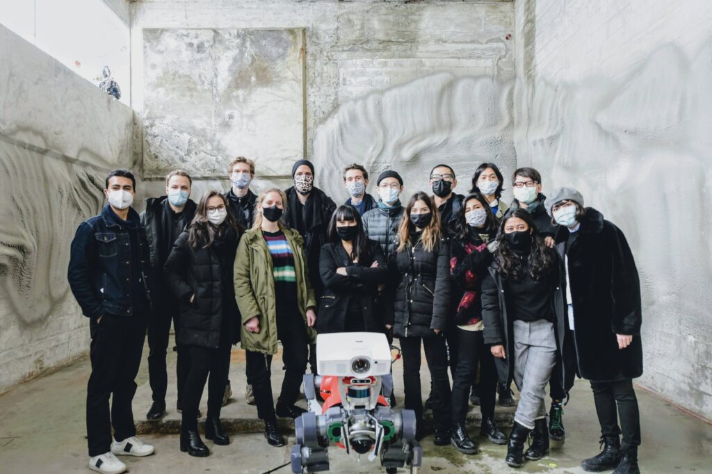 Team photo with robotic plastering setup